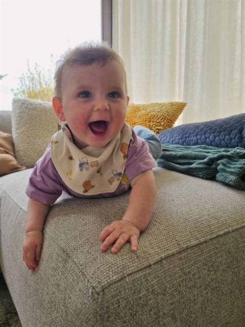 Smiling baby wearing a bib